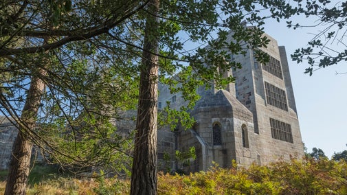 Exterior of Castle Drogo, looking up through the fir trees